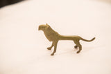 The distinct silhouette of a vintage Ashanti-style bronze lion gold weight.