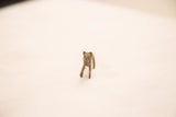 Stylized face and upright stance of a handmade vintage bronze lion gold weight.