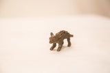 Side profile of a vintage bronze porcupine weight with textured quills and a dark patina.