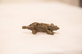 Underside view of the vintage bronze porcupine showing its four legs and dark patina.