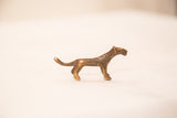 Profile view of a tiny cheetah bronze gold weight showing its handmade, rustic texture.
