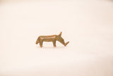 Side profile of a stylized bronze rhino, highlighting its handmade texture and aged patina.