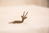 Profile of a vintage bronze resting gazelle showing its slender, handmade form.