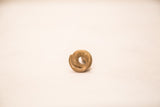 Top-down view of a vintage bronze snake weight, detailing the textured, spiraling coil.