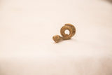 Angled profile of a coiled bronze snake showing its handmade texture.
