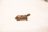 Vintage African bronze turtle gold weight with dark patina and spiral shell spots.