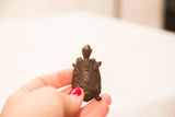 Overhead view of the handmade bronze turtle showing its dark patina and spiral shell designs.