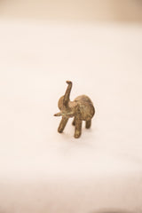 Vintage bronze elephant sculpture with oxidized blue-green patina and raised trunk.