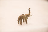 Vintage bronze elephant sculpture, displaying blue-green patina and textured finish.