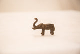 Side profile of a handmade bronze elephant sculpture showing its dark, textured patina.