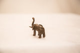 Rear view of a handmade bronze elephant sculpture highlighting its textured dark patina.