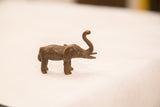 Vintage bronze elephant sculpture showing its textured, dark iron-like patina.