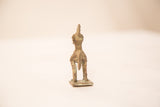 Back of a vintage bronze rooster gold weight, highlighting the figure's tail and oxidized texture.