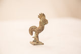 Vintage bronze rooster sculpture in profile showing its curved tail and green patina.