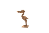 Vintage pelican bronze gold weight standing on a square base with a textured patina.