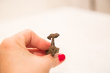 Overhead view of the hand-cast bronze pelican with a fish held firmly in its beak.