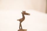 Side profile of a vintage African bronze pelican sculpture with a dark, textured patina.