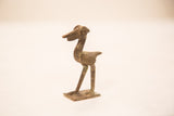 Textured body and elongated beak of a vintage African bronze pelican collectible.