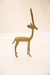 Vintage bronze gazelle sculpture in profile showing its slender legs and elongated horns.