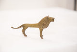 Vintage handmade bronze African lion sculpture, light green patina, full profile.