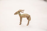 Vintage impala ram gold weight in profile, showing its oxidized bronze and green patina.
