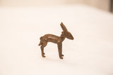 Handmade bronze impala ram sculpture, showing textured back and dark, iron-like patina.