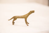 The elegant silhouette of a vintage bronze cheetah sculpture with a subtle green patina.