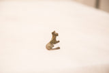 Handmade bronze resting cheetah sculpture, side profile showing aged green and golden patina.