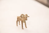 Handmade charm of a vintage bronze ram sculpture with its textured, oxidized patina.