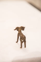 Rear view of a vintage bronze ram showing its handmade form and dark patina.