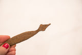 Hand-forged head of a vintage iron snake showing its rustic surface patina.