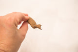 The rustic, pointed head of a small vintage African iron snake.