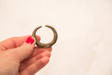 Vintage bronze gold weight showing its scale and rough, handmade surface patina.