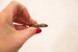 Side profile of the vintage bronze weight showing its handmade character and aged texture.