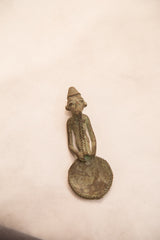 Angled view of a vintage Ashanti gold weight with a braided beard and oxidized bronze finish.