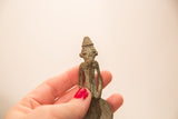 Vintage Ashanti bronze figure with a braided beard held to show scale and texture.