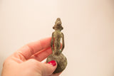 Rear view of a vintage Ashanti bronze spoon weight highlighting its slender form and patina.