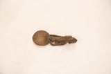 The sculpted form and aged patina of a vintage Ashanti gold weight spoon.