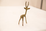 Slender bronze gazelle sculpture, showing handmade texture and subtle green patina.