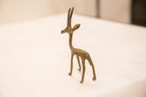 Slender, handmade bronze gazelle sculpture with subtle green patina.