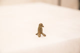 Vintage bronze bird gold weight with intricate textured surface and patina.