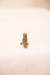 Rear view of the vintage bronze bird sculpture with a green-gold patina.