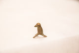 Vintage bronze bird sculpture with intricate texture and rich, oxidized patina.