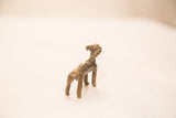 Twisted broken horn and back of an antique bronze antelope sculpture with shiny patina.