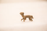 Side profile of the antique bronze meerkat sculpture showing its expressive stance.