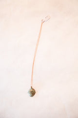 Full length view of the vintage African head pendant on its delicate chain.