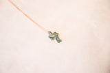 Angled view of the handmade frog pendant highlighting its blue oxidized finish.