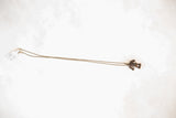 Vintage African frog pendant necklace laid out to show its full length and dark patina.