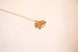 Angled view of the vintage chameleon pendant showing its handmade bronze texture.