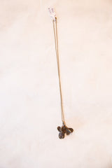 Vintage African fish pendant necklace hanging from its full-length chain.